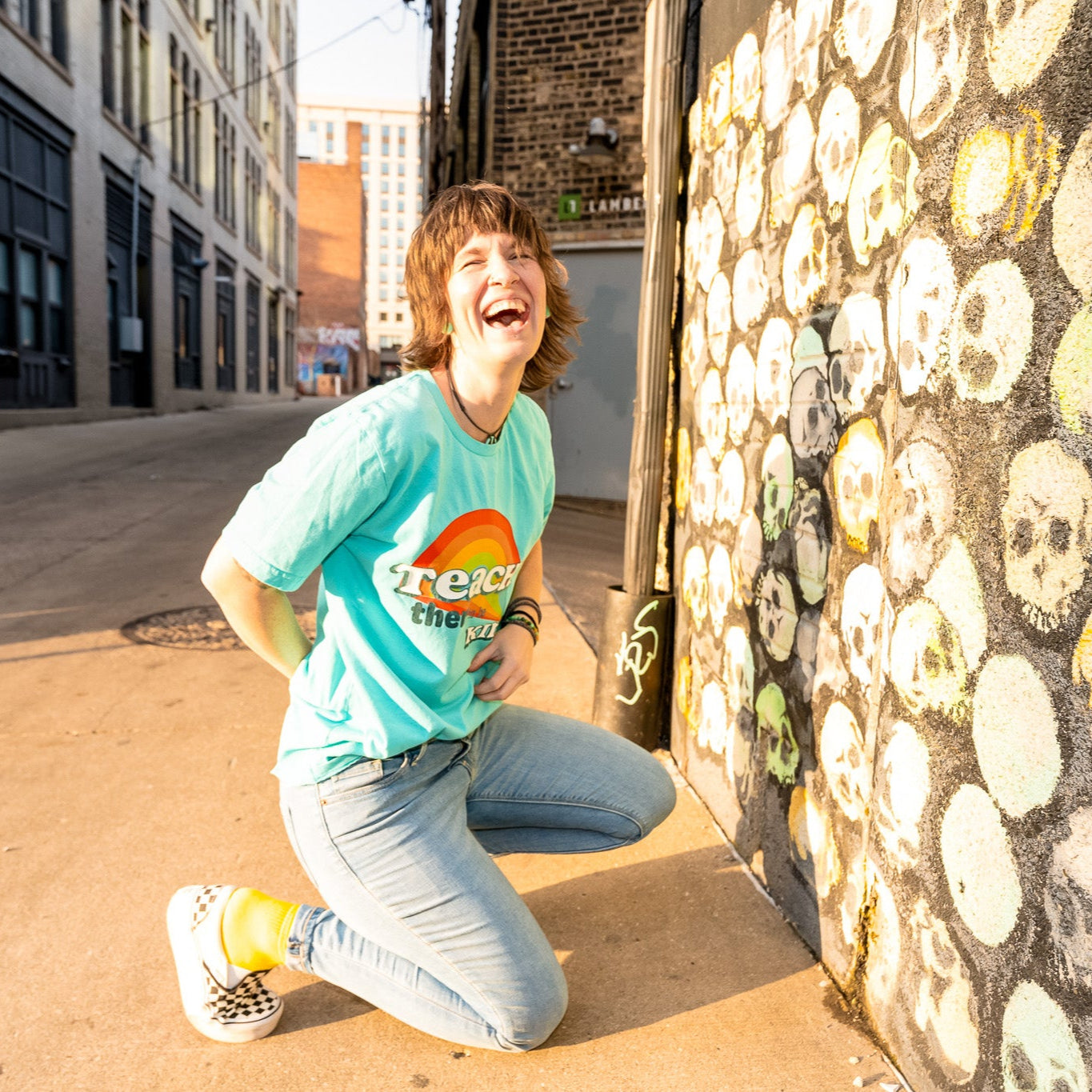 Brittany laughing in the Teach them to be kind rainbow shirt
